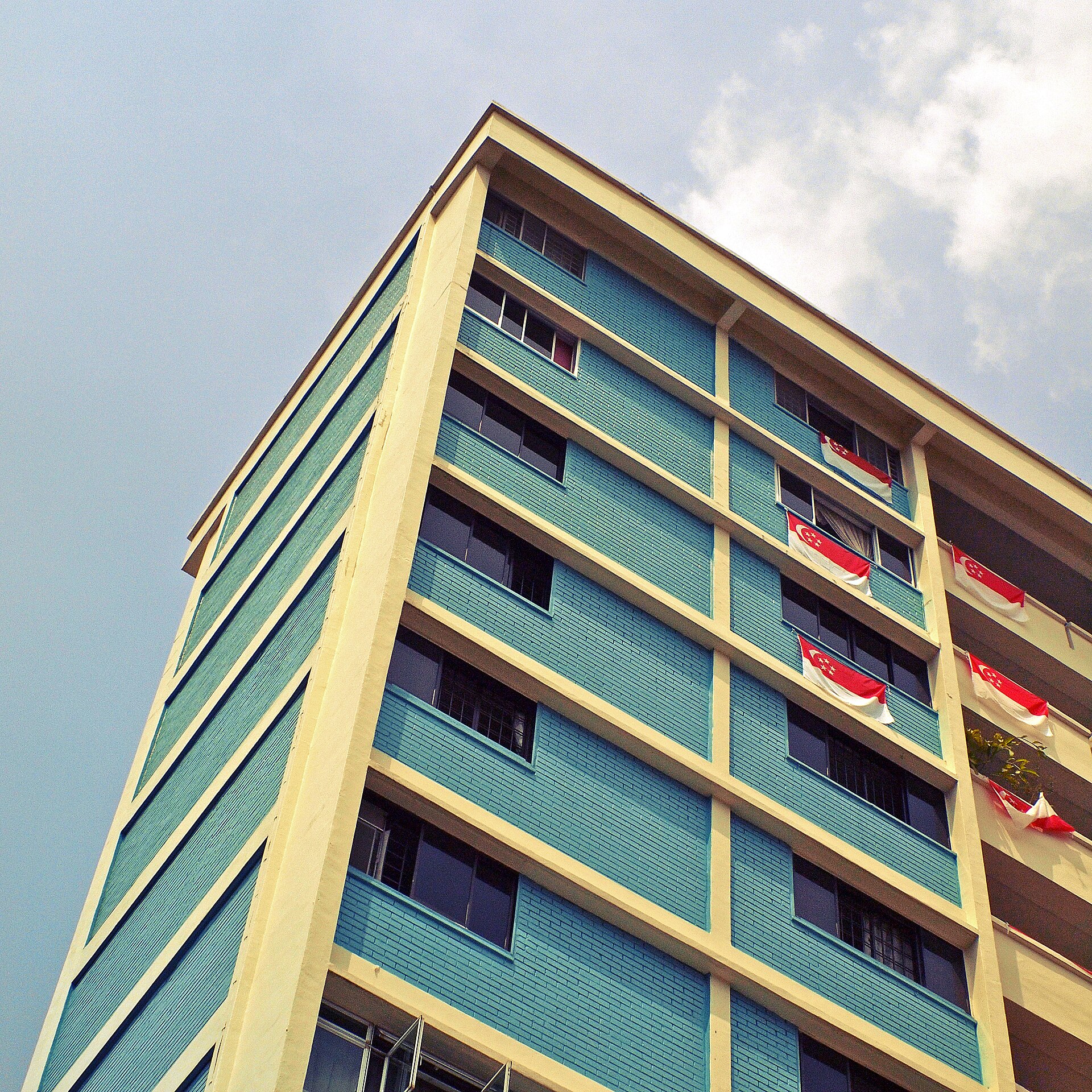 Block of Housing and Development Board flats in Singapore decorated with national flags