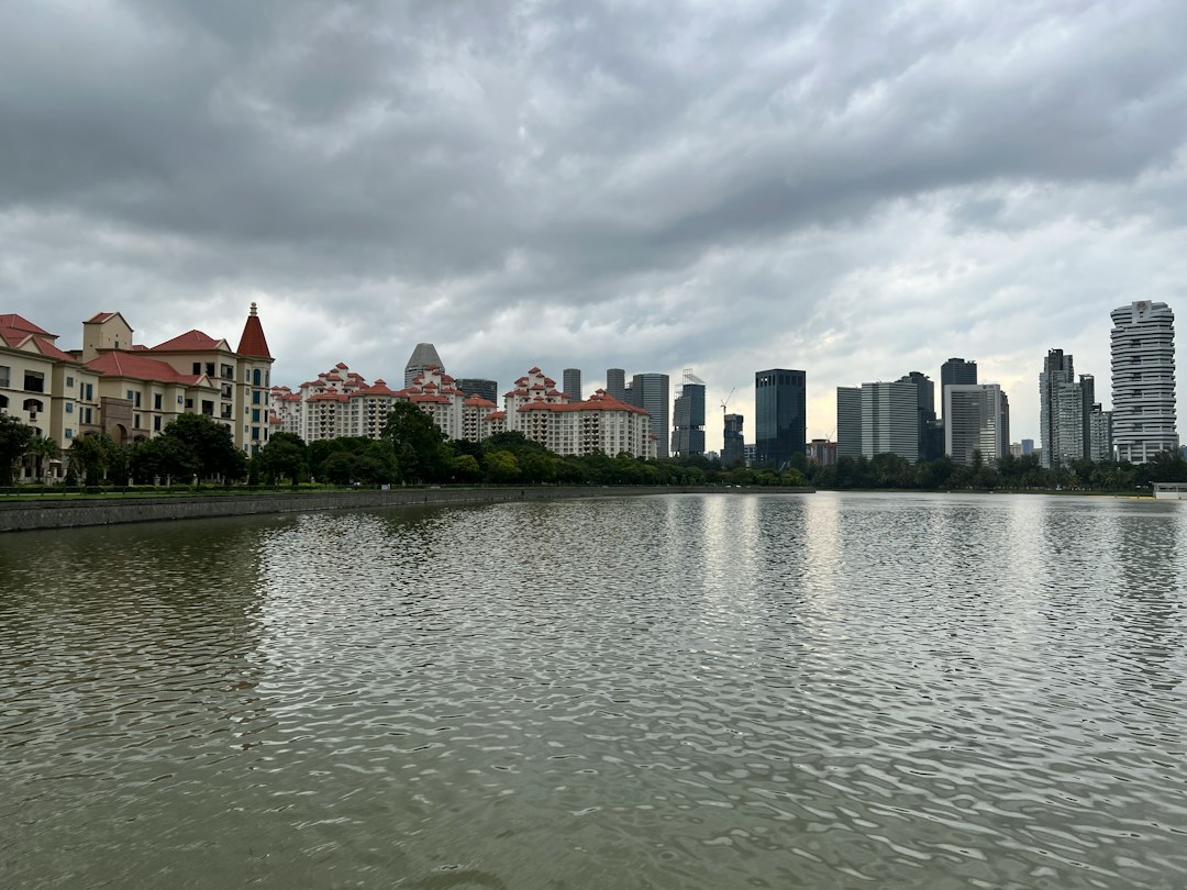 A body of water with buildings in the background