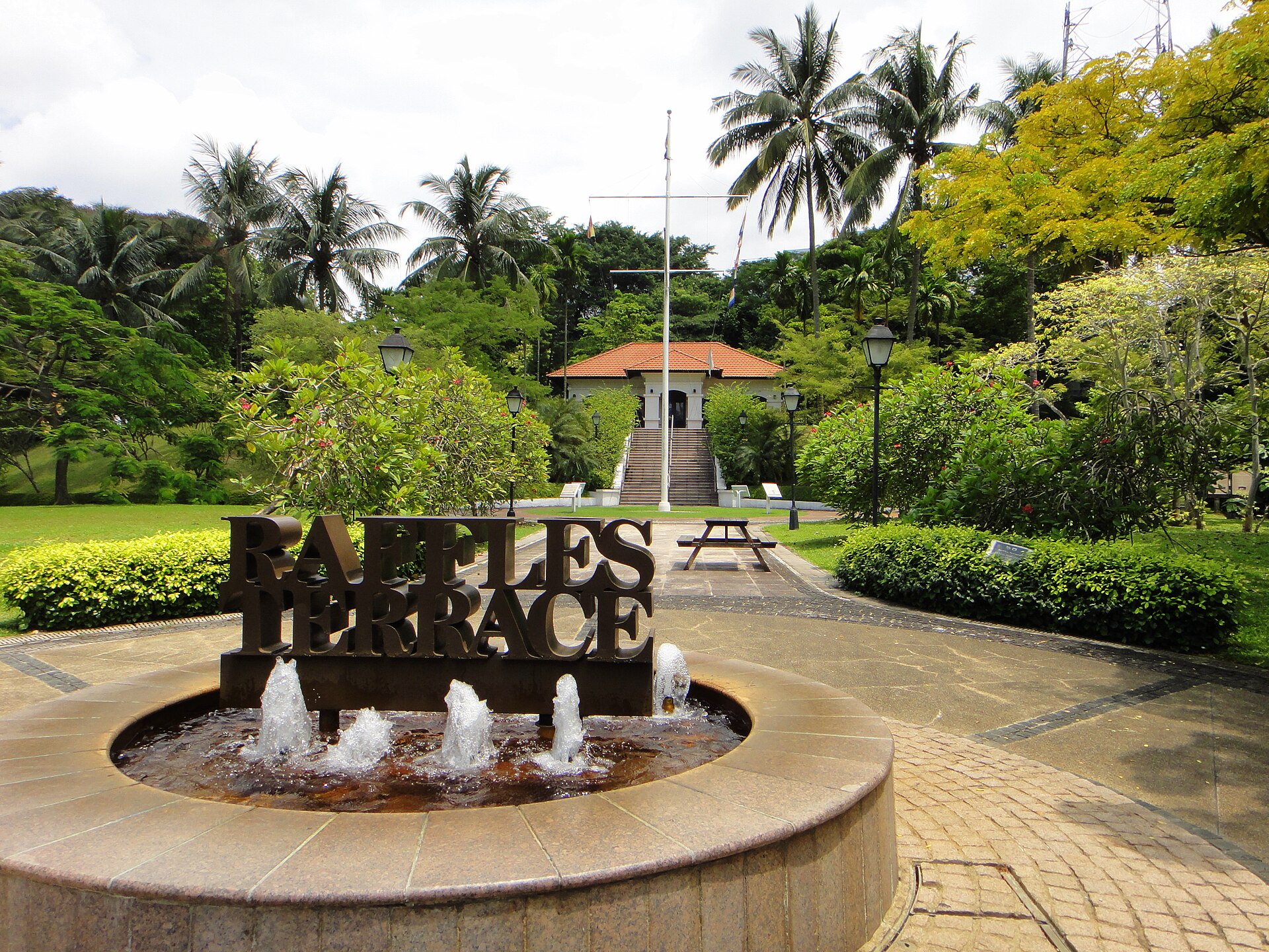 Raffles Terrace in Fort Canning Park, Singapore. In the background are a flagstaff and Raffles House